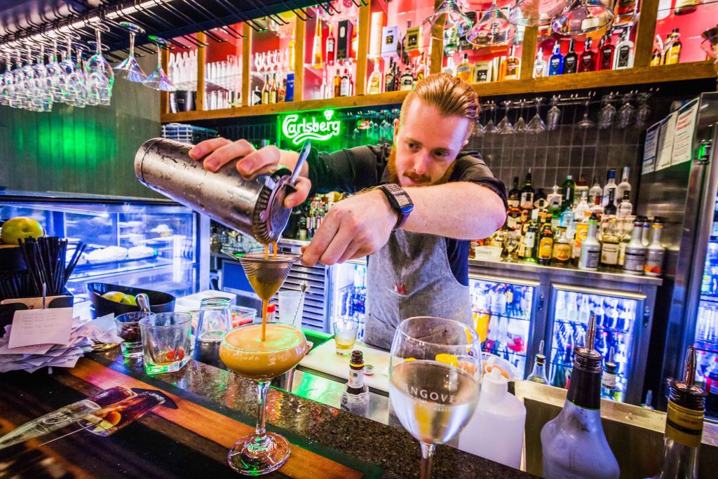 bartender pours drink