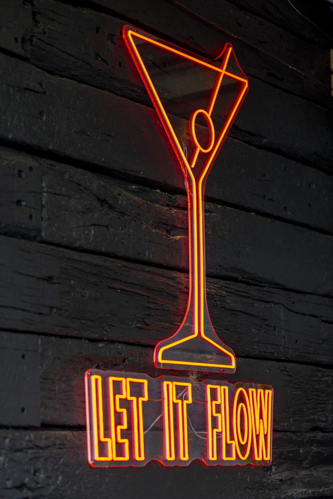 light up sign on wall of bar