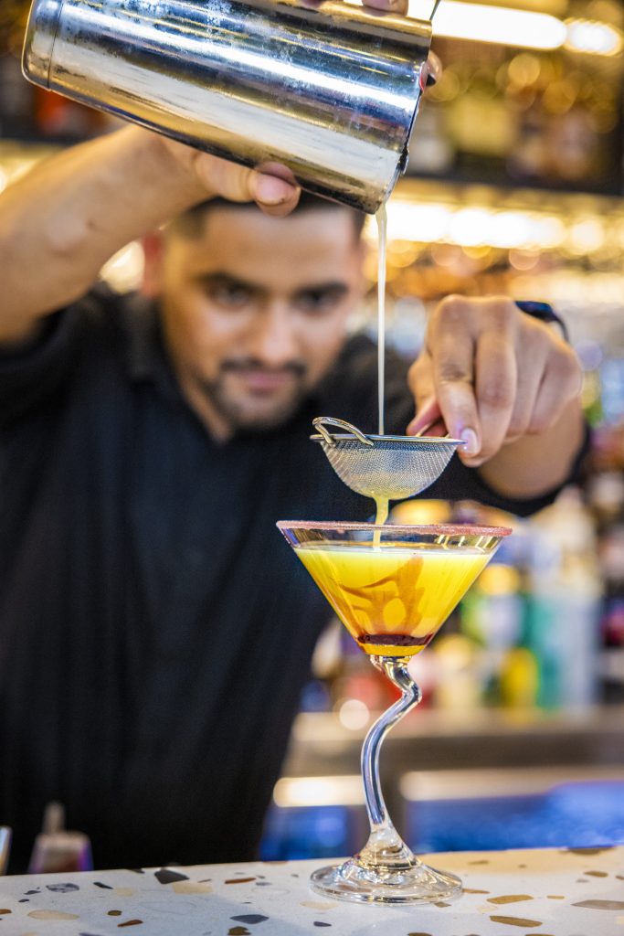 bartender pours cocktail