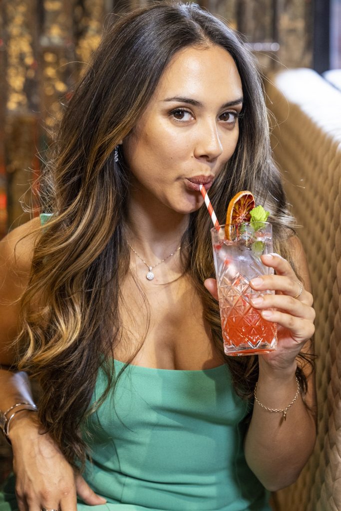 woman drinking cocktail