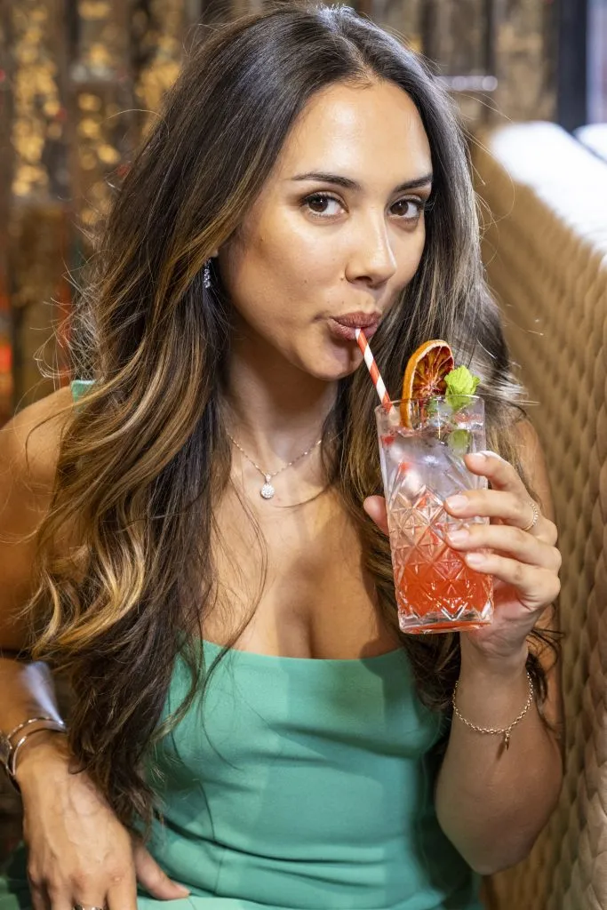 woman drinking cocktail